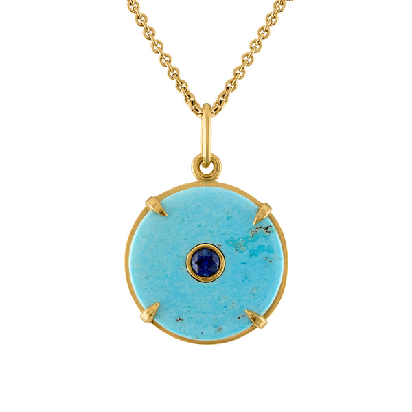 Turquoise circle pendant set in 18k gold with center blue sapphire stone